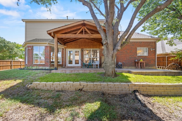 back of house with french doors, a fenced backyard, and a patio area