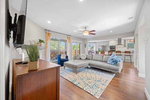 staircase with baseboards, a towering ceiling, and wood finished floors
