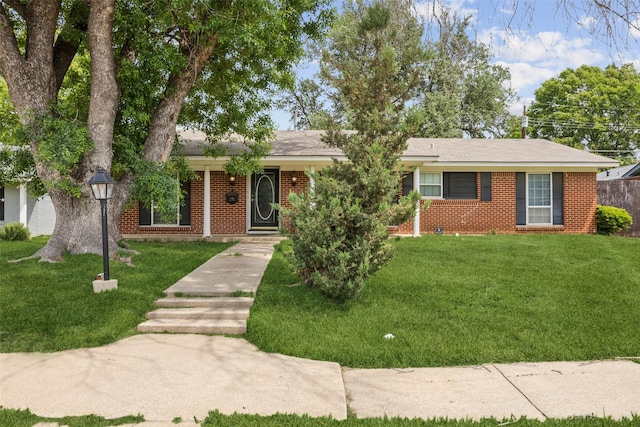 single story home featuring a front yard and brick siding