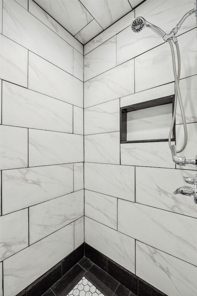 bathroom with tiled shower