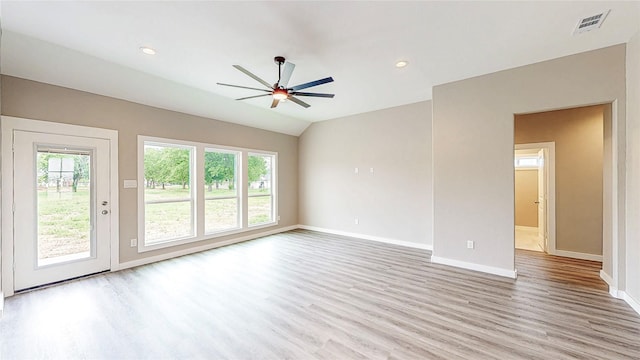 unfurnished living room featuring baseboards, plenty of natural light, a ceiling fan, and light wood-style flooring