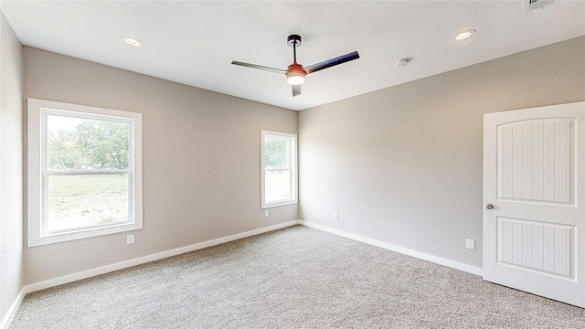 carpeted empty room featuring baseboards, a ceiling fan, recessed lighting, and a wealth of natural light