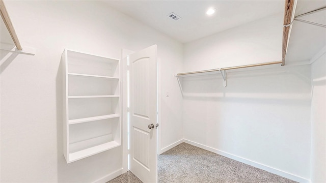 spacious closet with carpet flooring and visible vents