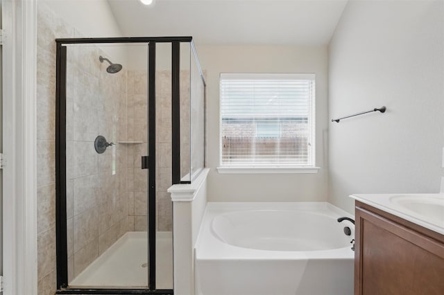 bathroom featuring vanity, a bath, and a stall shower
