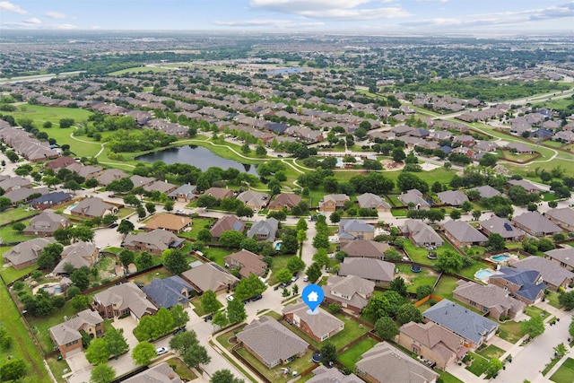 drone / aerial view with a water view and a residential view
