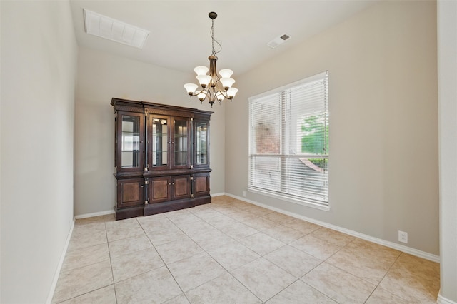 spare room featuring visible vents, baseboards, light tile patterned floors, and a chandelier
