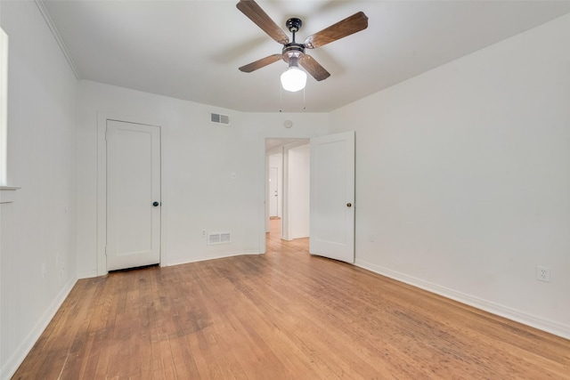unfurnished bedroom with a ceiling fan, baseboards, visible vents, and light wood finished floors