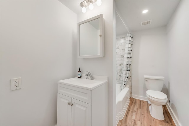 full bathroom featuring visible vents, wood finished floors, vanity, baseboards, and toilet