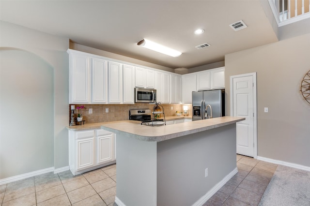 kitchen with stainless steel appliances, visible vents, and light tile patterned floors