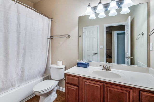 bathroom with vanity, toilet, baseboards, wood finished floors, and shower / tub combo