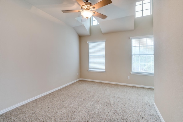 carpeted spare room featuring baseboards, ceiling fan, and a healthy amount of sunlight