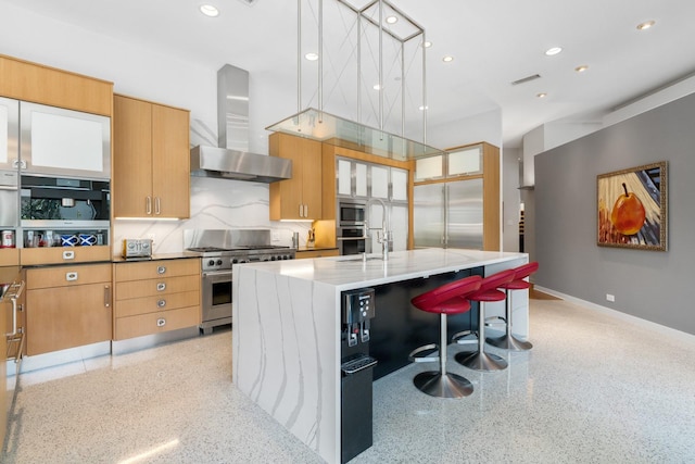 11715 Parwen Dr, Dallas, TX 75230 - kitchen with visible vents, built in appliances, a kitchen island with sink, light speckled floor, and wall chimney exhaust hood