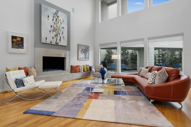 11715 Parwen Dr, Dallas, TX 75230 - living area featuring a high end fireplace, plenty of natural light, wood finished floors, and a high ceiling