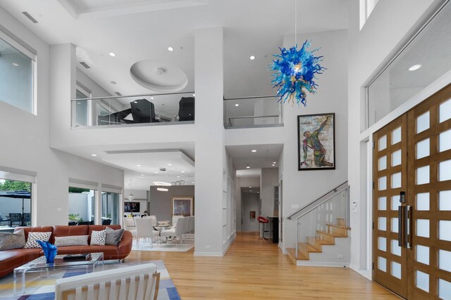 11715 Parwen Dr, Dallas, TX 75230 - foyer entrance featuring recessed lighting, a towering ceiling, wood finished floors, and stairway