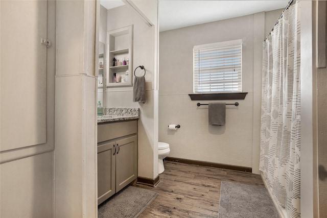 full bath with vanity, wood finished floors, toilet, and curtained shower