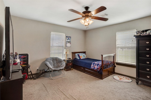 bedroom featuring carpet floors, baseboards, ceiling fan, and visible vents