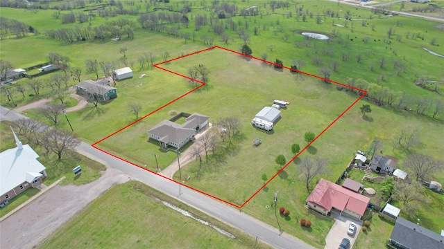 birds eye view of property with a rural view