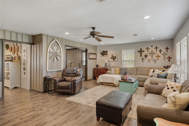 living room with a ceiling fan, recessed lighting, wood finished floors, and visible vents