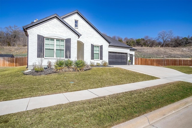 view of front of house with driveway, a front yard, a garage, brick siding, and fence