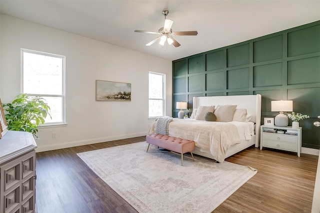 bedroom with baseboards, dark wood-style flooring, and ceiling fan