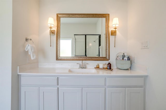 bathroom featuring vanity and a shower with door