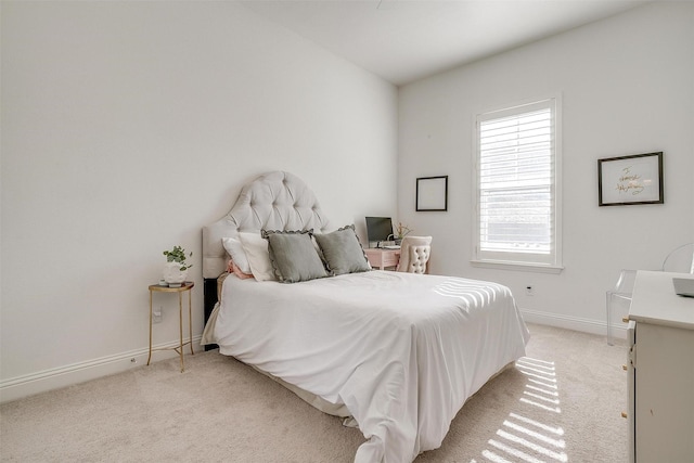 bedroom featuring baseboards and light carpet