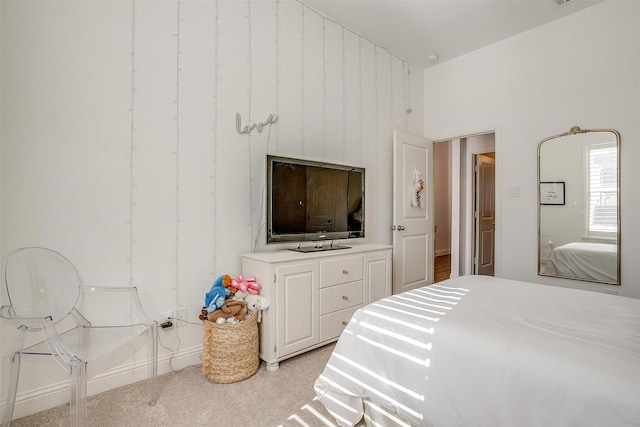 bedroom with light colored carpet and a towering ceiling
