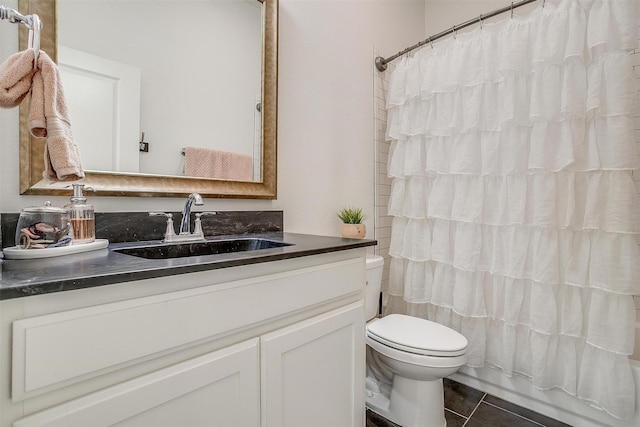 bathroom with vanity, tile patterned flooring, toilet, and curtained shower