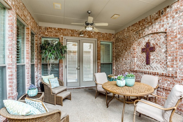 sunroom / solarium featuring french doors and a ceiling fan