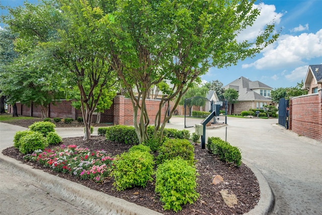 view of home's community with fence, a gate, and a residential view