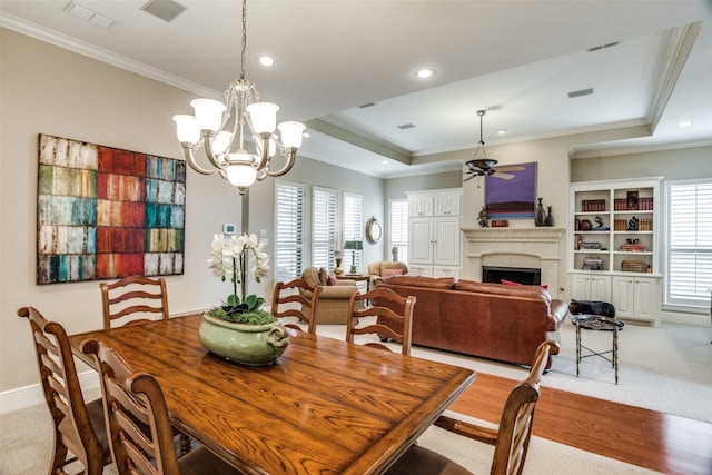 dining area with a wealth of natural light, ornamental molding, and visible vents