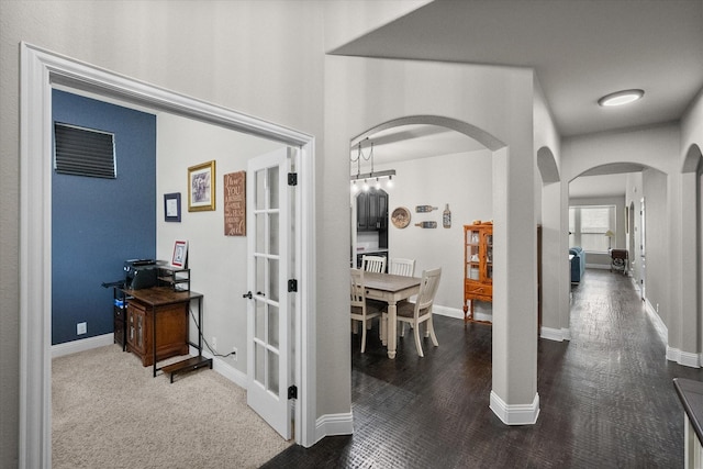 2114 Burke Dr, Princeton, TX 75407 - hallway featuring arched walkways, baseboards, french doors, and wood finished floors