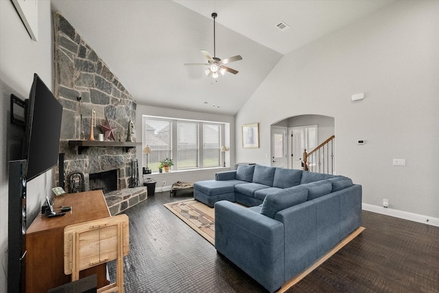 2114 Burke Dr, Princeton, TX 75407 - living room featuring visible vents, baseboards, a stone fireplace, ceiling fan, and arched walkways