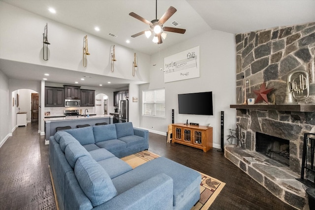 2114 Burke Dr, Princeton, TX 75407 - living room featuring arched walkways, ceiling fan, and baseboards