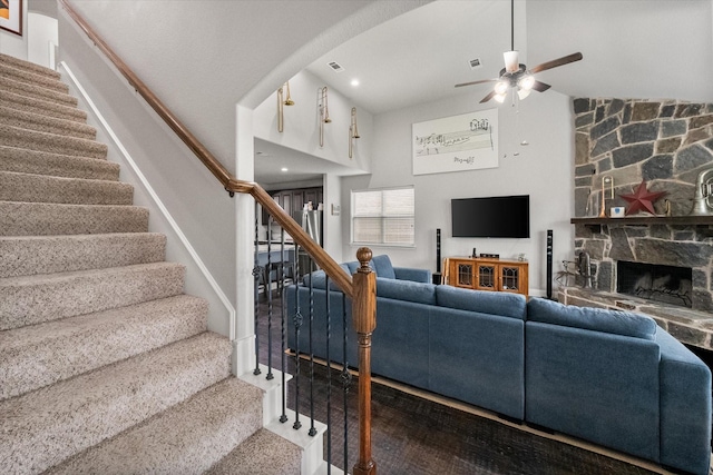 2114 Burke Dr, Princeton, TX 75407 - living area featuring stairs, a ceiling fan, visible vents, and a stone fireplace
