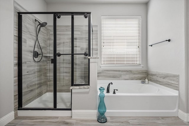 2114 Burke Dr, Princeton, TX 75407 - bathroom with baseboards, a stall shower, and a garden tub