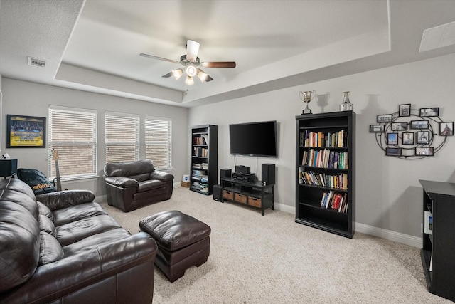 2114 Burke Dr, Princeton, TX 75407 - living room with a ceiling fan, visible vents, baseboards, a tray ceiling, and carpet flooring