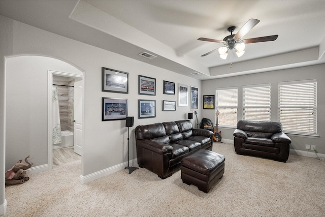 2114 Burke Dr, Princeton, TX 75407 - carpeted living room featuring ceiling fan, visible vents, arched walkways, a raised ceiling, and baseboards