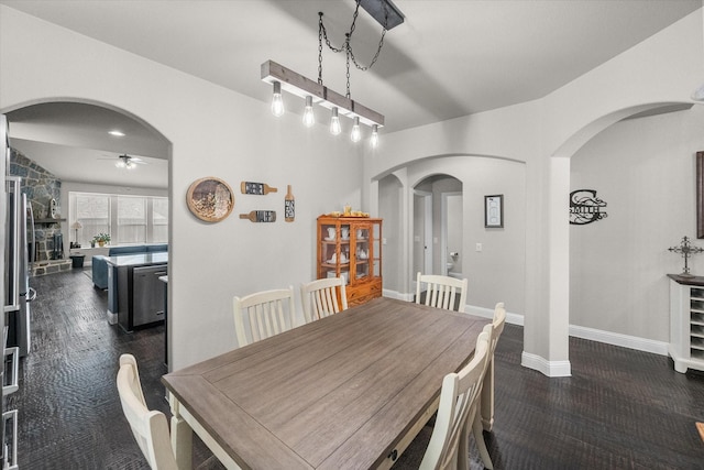 2114 Burke Dr, Princeton, TX 75407 - dining area featuring arched walkways, ceiling fan, and baseboards