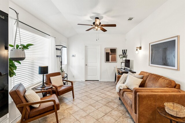 living area with visible vents, lofted ceiling, baseboards, a ceiling fan, and light tile patterned floors