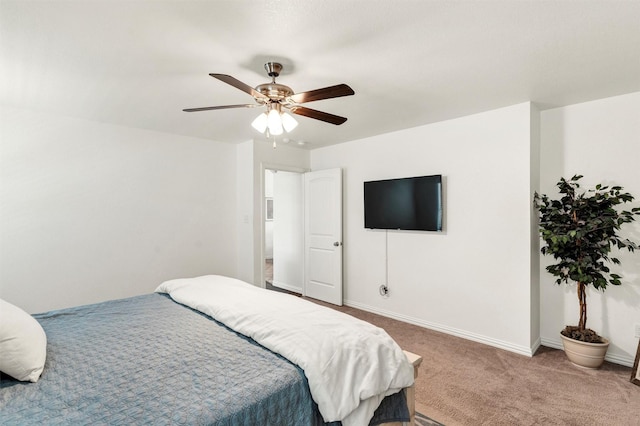bedroom featuring baseboards, ceiling fan, and carpet