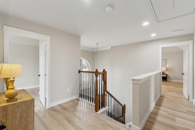 corridor with attic access, baseboards, an upstairs landing, recessed lighting, and light wood-style flooring