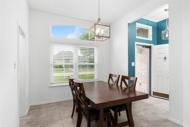 dining room featuring light tile patterned flooring, baseboards, and an inviting chandelier