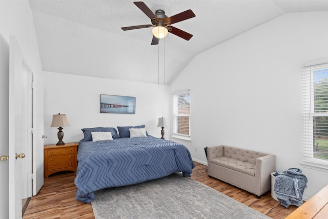 7129 Dee Cole Dr, The Colony, TX 75056 - bedroom with vaulted ceiling, light wood finished floors, and ceiling fan