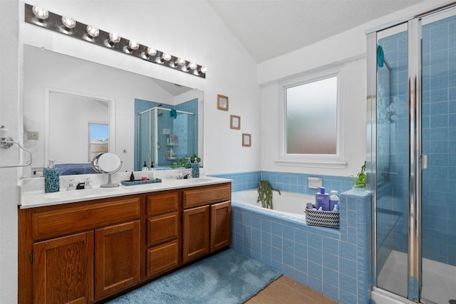 7129 Dee Cole Dr, The Colony, TX 75056 - full bathroom featuring vaulted ceiling, tile patterned floors, a shower stall, double vanity, and a garden tub