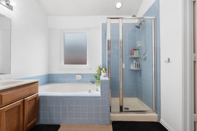 bathroom with vanity, a bath, tile patterned flooring, and a stall shower