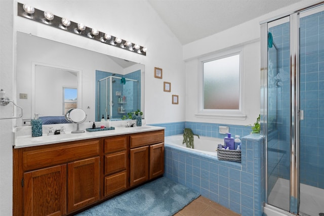 7129 Dee Cole Dr, The Colony, TX 75056 - bathroom with a stall shower, tile patterned flooring, double vanity, vaulted ceiling, and a bath