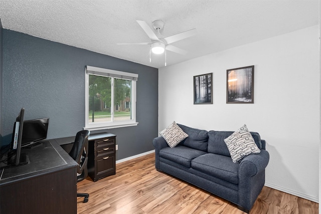7129 Dee Cole Dr, The Colony, TX 75056 - office area featuring light wood-style floors, a ceiling fan, and a textured ceiling