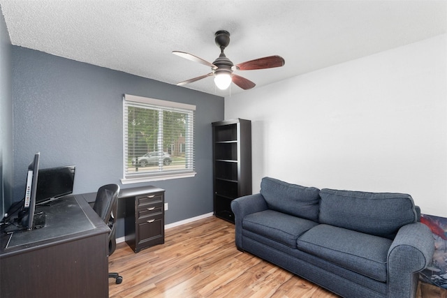 office with light wood-type flooring, a ceiling fan, and baseboards
