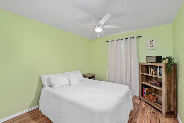 7129 Dee Cole Dr, The Colony, TX 75056 - bedroom featuring wood finished floors and ceiling fan